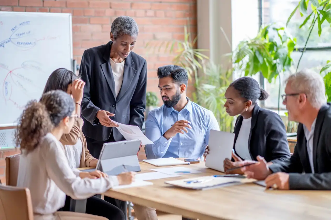 Business team meeting around a conference table.