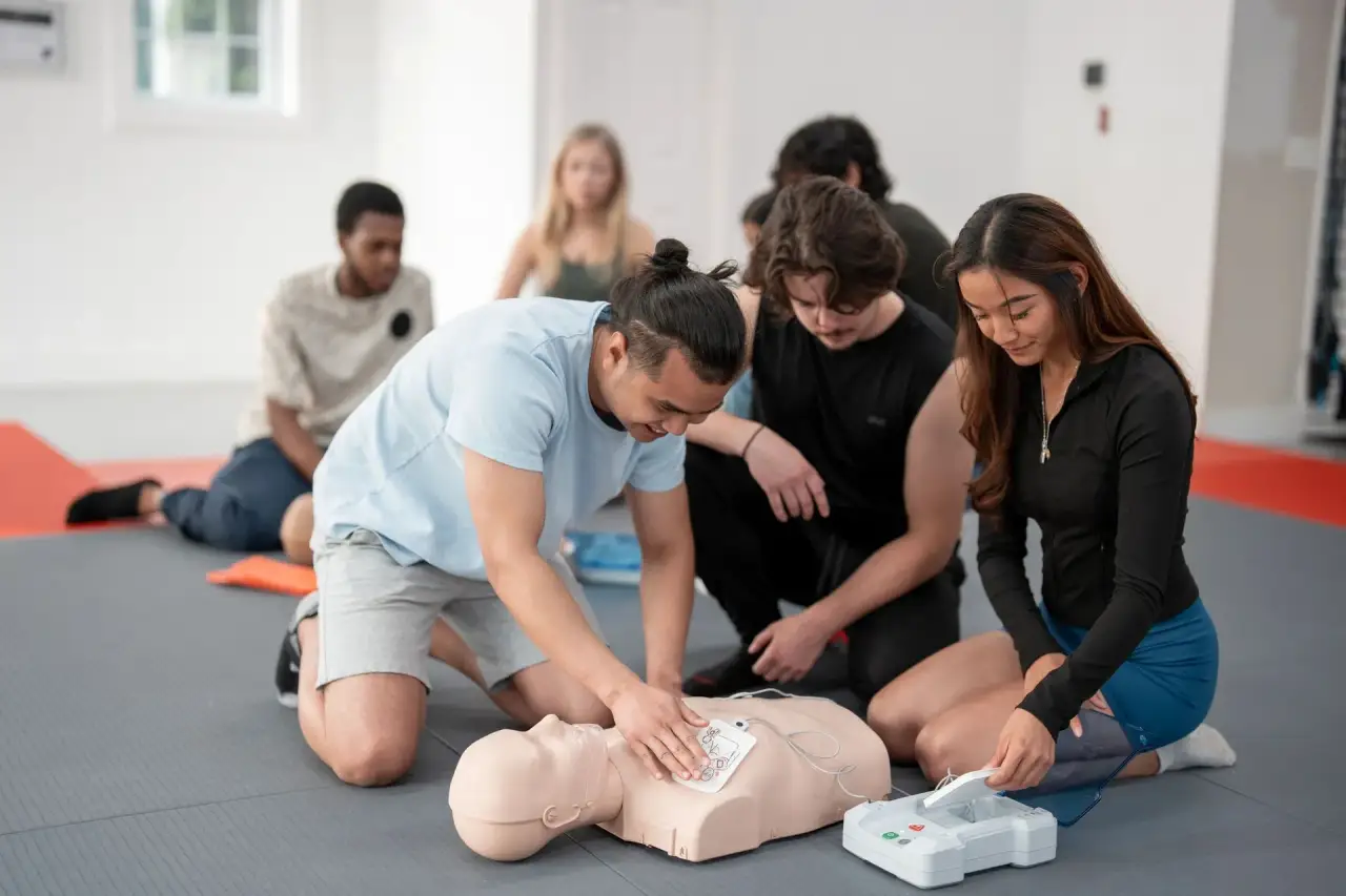 People crouched around someone on the ground (top cropped).